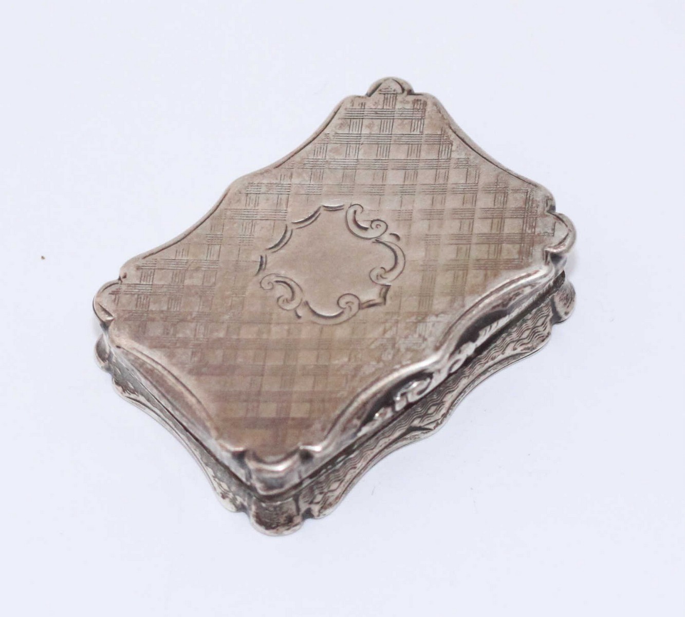 A Victorian silver vinaigrette, of serpentine rectangular form, with floral pierced grill,