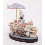 A large Lladro porcelain figurine 'Flowers of the Season' no.1454, depicting a female flower vendor,