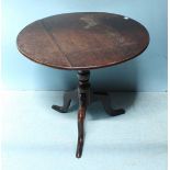 A circular tilt-top oak table, raised on tripod base. 72cm diameter.