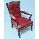 A 19th century stained armchair with button back and red fabric upholstery, frilled gimp and