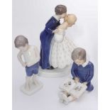 Three assorted Bing and Grondahl porcelain figures including a couple kissing, a boy dressing and