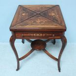 A late Victorian rosewood envelope card table the top decorated with scrolling foliate inlay,