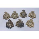 Seven various King's Own Foreign Service brass helmet plates, including 4th Lancaster, 68th