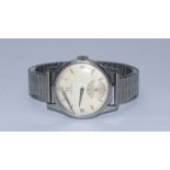 A gents Omega wristwatch c.1951, the silvered dial with batons denoting hours, Arabic numerals at