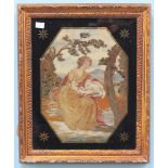 A late 18th/ early 19th century Silkwork pictures of a Shepherdess resting with a sheep, in giltwood