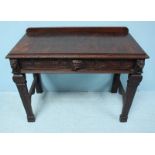 A Victorian carved and fumed oak side table of rectangular form, with single frieze drawer with mask
