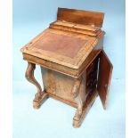 A Victorian walnut Davenport, with fitted compartment above a hinged top with brown leather