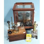 An Oertling oak cased set of chemical balance scales including a cased set of weights, together with