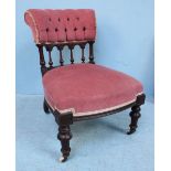 A Victorian mahogany nursing chair, the button back, above spindles, with salmon fabric upholstery