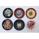 Six various Moorcroft pottery pin dishes decorated with typical stylized flowers, all boxed (6)