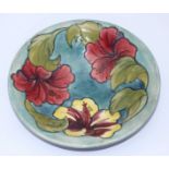 A Moorcroft pottery bowl in the 'Hibiscus' pattern, with Moorcroft paper label and impressed factory