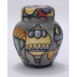 A small Moorcroft pottery ginger jar and cover in the 'Balloons 99' pattern designed by Jeanne