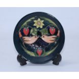 A Moorcroft pottery pin dish decorated with birds and strawberries in the 'Strawberry Thief' pattern