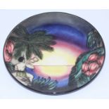 A Moorcroft pottery 'Birth of Light' circular Year Plate 2000, decorated with a figure under palm