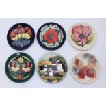 Six various Moorcroft pottery pin dishes including 'Puffins' 'Strawberry Thief,' 'Butterfly,' '
