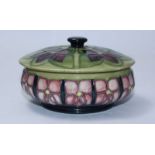 A Moorcroft pottery Powder Bowl & Cover of compressed globular form, decorated in the 'Violets'