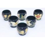 A set of six Moorcroft Egg Cups painted with flowers in the 'Narcissi' pattern, copyright 2002, '