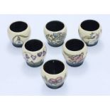 A set of six Moorcroft Egg Cups painted with flowers in the 'Spring Festival' pattern, each cup