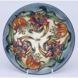 A Moorcroft pottery Year plate '1999' decorated in the 'Tiger Lily' pattern, limited edition 67/750,