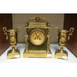 An Empire style gilt brass clock garniture, comprising of a Grecian form clock, the gold dial with