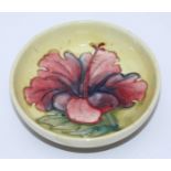 A small Moorcroft pottery bowl in the 'Yellow Hibiscus' pattern, with impressed factory marks to