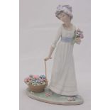 A boxed Lladro porcelain figure of a lady with flowers, 'no. 5030', 27cm high.