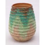 A Clarice Cliff 'Raffia Ware' pottery vase of tapering cylindrical form, decorated in shades of