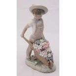 A boxed Lladro porcelain figure of a child with a wheelbarrow of flowers, 'no.1283', 24cm high.