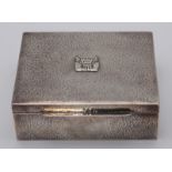 A South American, probably Colombian, silver cigarette box, with all over hammered decoration and