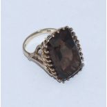 A 9ct gold ladies dress ring, claw-set with a large rectangular faceted smokey quartz and fancy