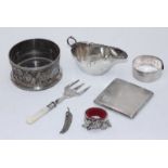 A small collection of assorted silver items including a sauce boat, a bangle and a cigarette case,