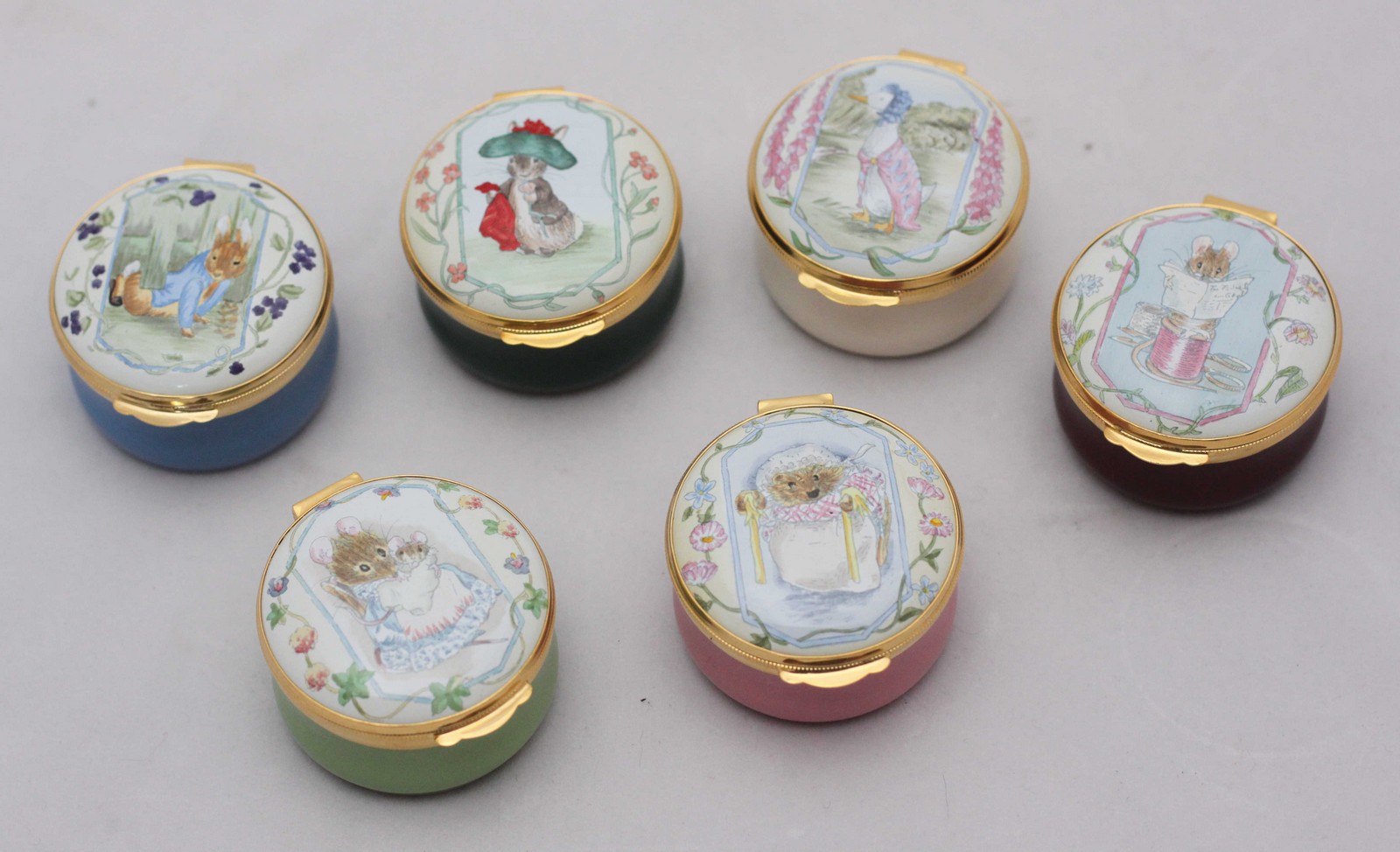 A set of six Crummles & Co circular enamel pill boxes including Peter Rabbit, Benjamin, Jemima