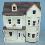 A 20th century New England style dolls house, together with associated dolls house furniture,