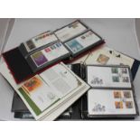 A collection of approximately 145 first day covers across two albums, together with an album of '