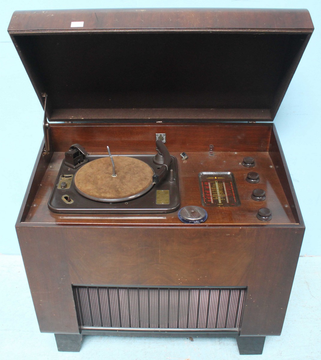 A Bush type 'RG11A' standing radio and record player, housed in mahogany case and raised on