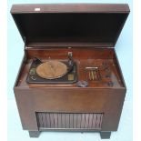 A Bush type 'RG11A' standing radio and record player, housed in mahogany case and raised on