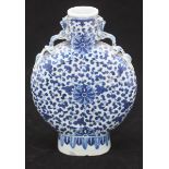 A Chinese porcelain moon flask, of typical form with blue and white foliate decoration and