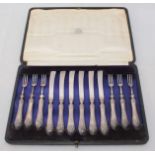 An Edwardian silver six-place dessert set of knives and forks, with shell-capped handles, Sheffield,