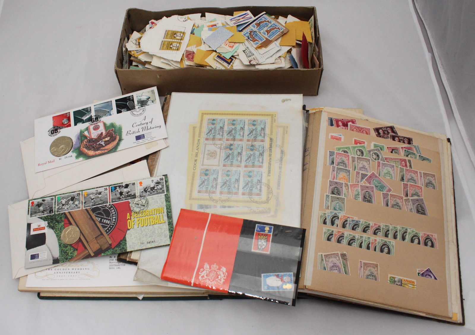 A collection of assorted unused world stamps across two albums, one with ERII definitives, some