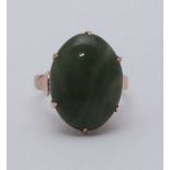 An 18ct gold ring, six-claw set with an oval cabochon polished jade, gross weight approximately 5.