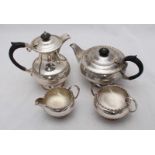 A four-piece silver tea set by Walker and Hall, with beaded decoration and ebonised handles to tea