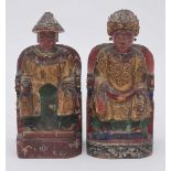 A pair of Chinese carved wood polychrome and gilded figures of a seated Emperor and Empress with