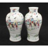 A pair of Chinese porcelain vases of baluster form, decorated in polychrome enamels with scenes of