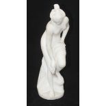 A carved white marble figure of a semi-naked Venus, drying her legs with drapery, 45cm high