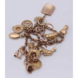 A 9ct gold Albert watch chain double-charm bracelet with sixteen charms, including 9ct, 18ct and a