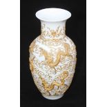 A Chinese porcelain vase of baluster form, profusely decorated with gilt tube-lined dragons, pagodas