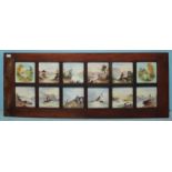 A framed matched-set of twelve 19th century ceramic tiles, 10 hand-painted landscape and seascape