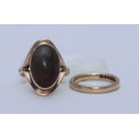 A 9ct ring set with an oval polished cabochon stone, possibly jadite, 5.61g, and a 9ct gold