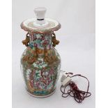 A Chinese Canton porcelain vase, converted to a lamp and decorated in polychrome enamels, with
