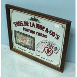A reproduction mirror advertising sign for 'This. De La Rue & Co's' playing cards. 48 x 58cm